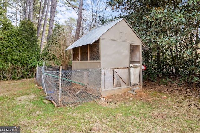 view of outbuilding featuring a lawn