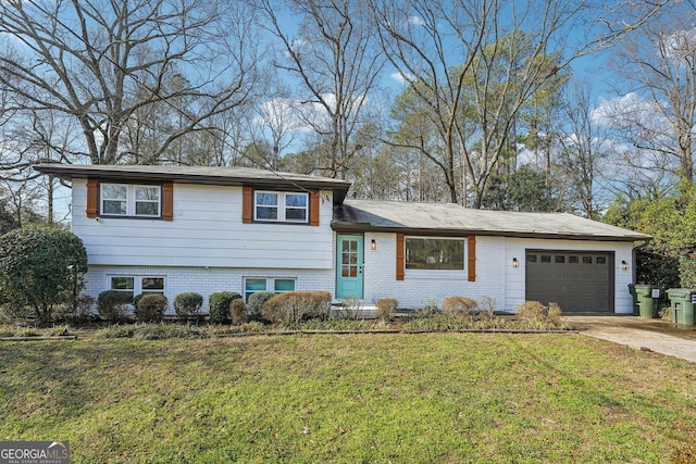 tri-level home with a garage and a front lawn