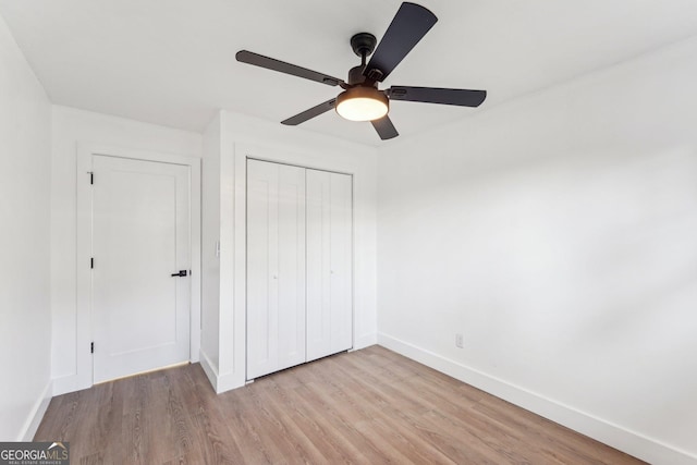 unfurnished bedroom with a closet, ceiling fan, and light hardwood / wood-style flooring