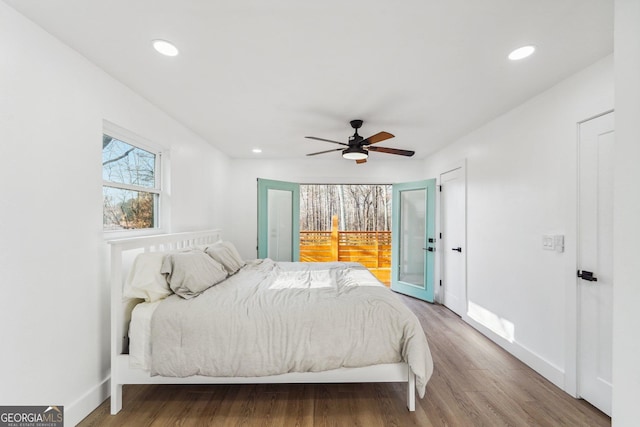 bedroom with hardwood / wood-style floors, access to exterior, and ceiling fan