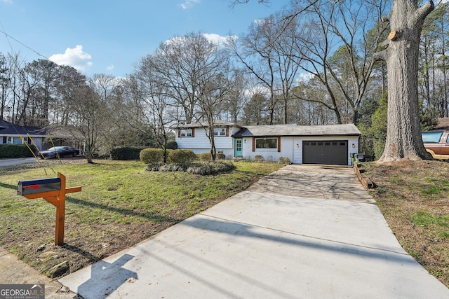 view of front of house with a garage and a front yard