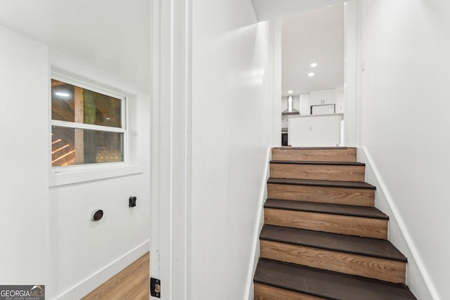 stairs featuring wood-type flooring