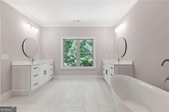 bathroom with vanity, ornamental molding, and a bathing tub