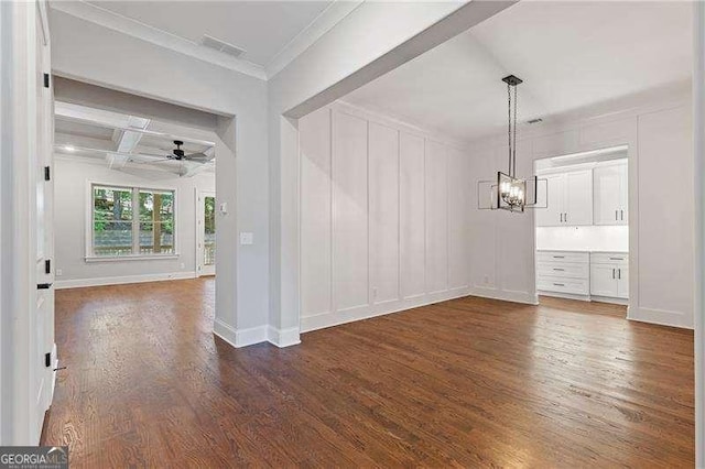 unfurnished room with coffered ceiling, crown molding, dark hardwood / wood-style flooring, beam ceiling, and ceiling fan with notable chandelier