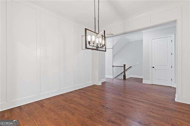 unfurnished dining area featuring dark hardwood / wood-style floors and a chandelier