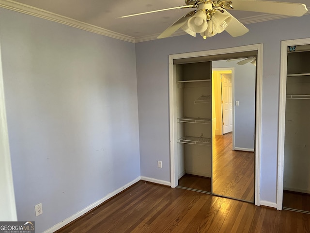 unfurnished bedroom with dark hardwood / wood-style flooring, ornamental molding, a closet, and ceiling fan