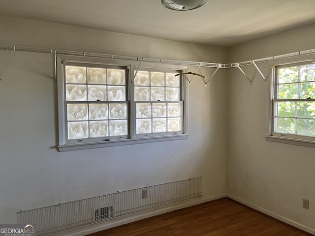 unfurnished room featuring dark wood-type flooring