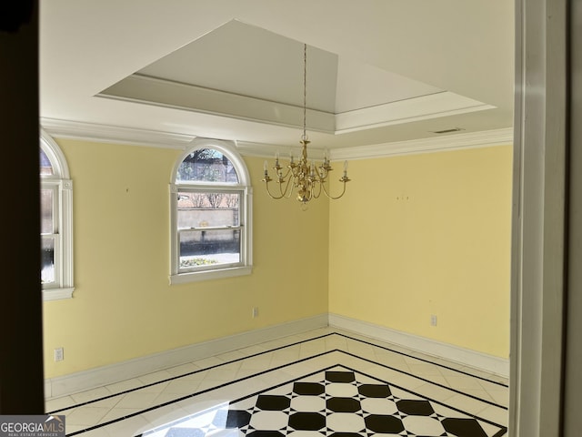 empty room with tile patterned flooring, crown molding, a chandelier, and a tray ceiling