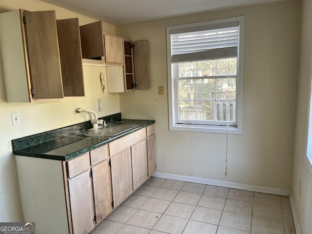 kitchen featuring sink and light tile patterned floors