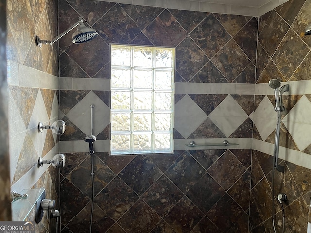 bathroom with a tile shower