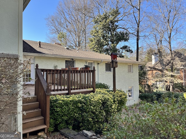 rear view of property featuring a wooden deck