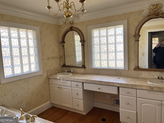 bathroom with vanity, hardwood / wood-style floors, ornamental molding, and an inviting chandelier