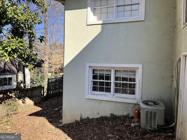 view of side of home with central air condition unit