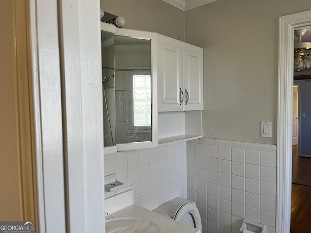 bathroom with vanity, tile walls, crown molding, and toilet