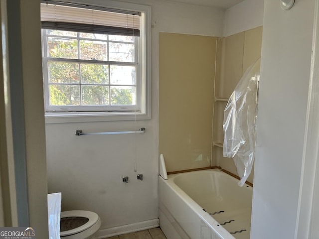 bathroom with toilet and a tub