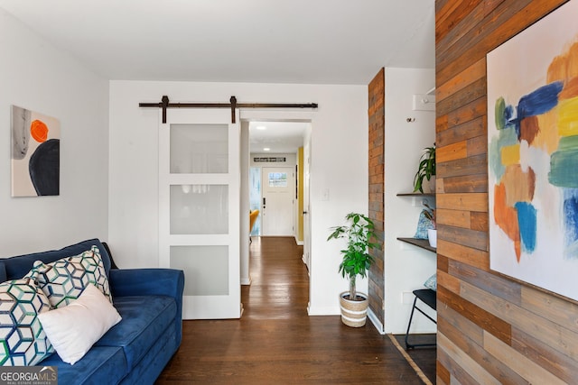 living room with dark wood-type flooring and a barn door