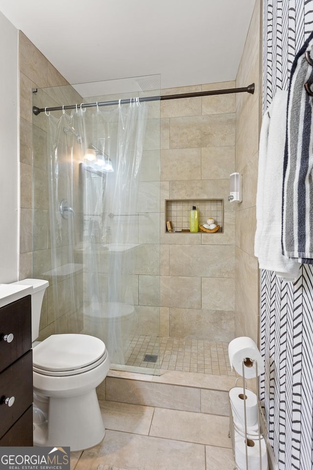 bathroom with a shower with curtain, tile patterned floors, vanity, and toilet