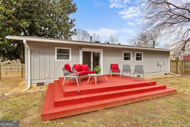 rear view of house with a wooden deck and a yard