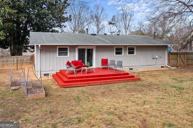 back of property with a wooden deck and a yard