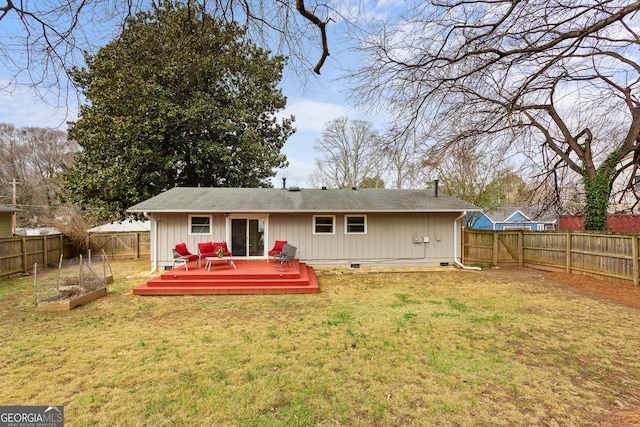 rear view of property with a wooden deck and a yard