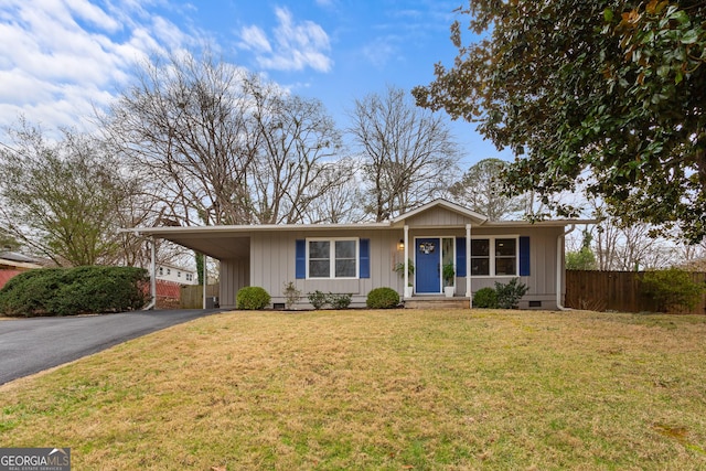 ranch-style house featuring a carport and a front yard