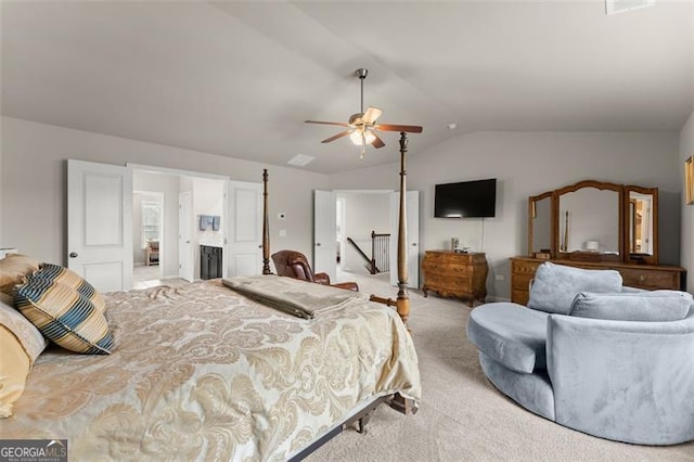 bedroom featuring ceiling fan, vaulted ceiling, and light carpet