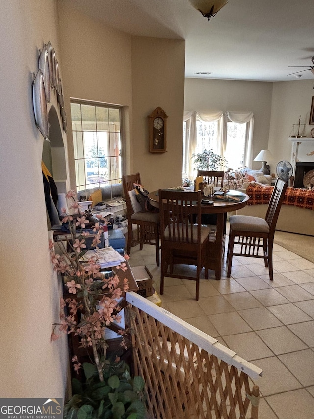 dining room featuring visible vents, ceiling fan, and tile patterned floors