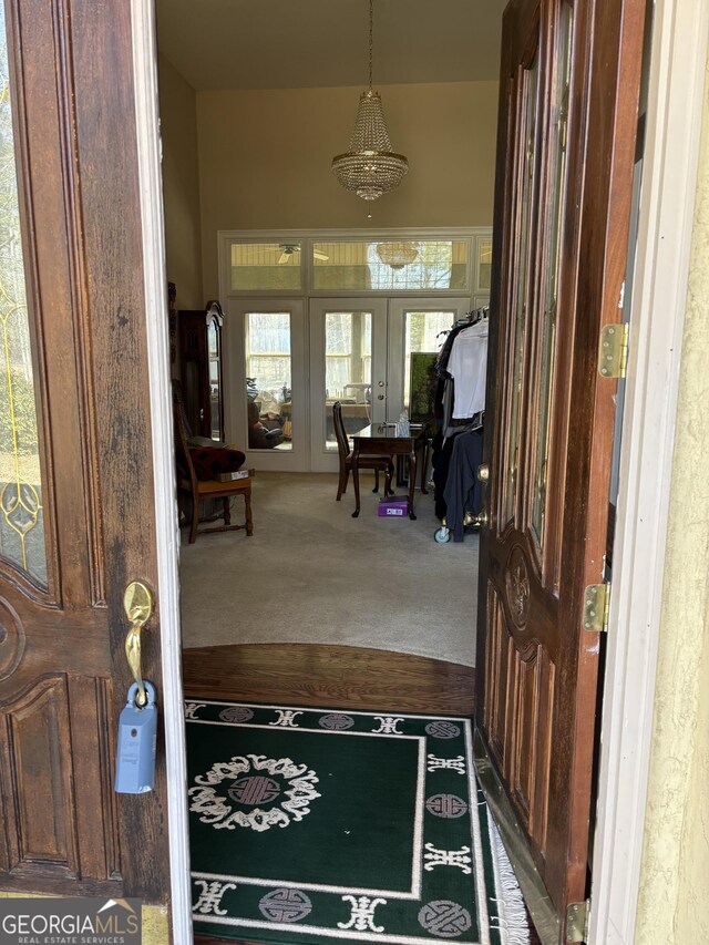 carpeted foyer entrance featuring french doors