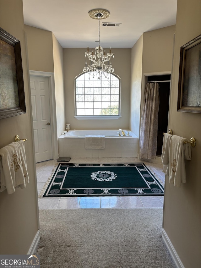 bathroom featuring a chandelier, a garden tub, visible vents, baseboards, and tile patterned floors