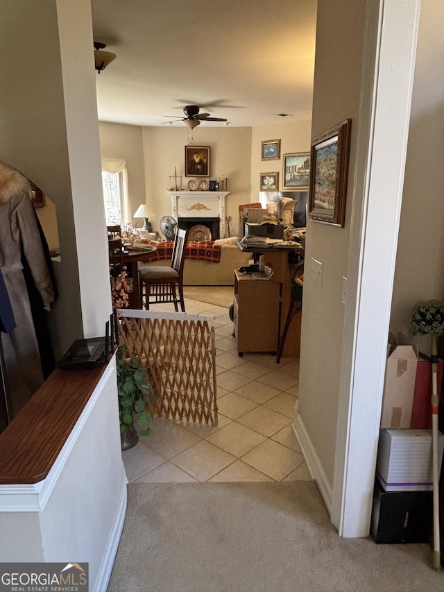 hallway with light tile patterned floors and light colored carpet