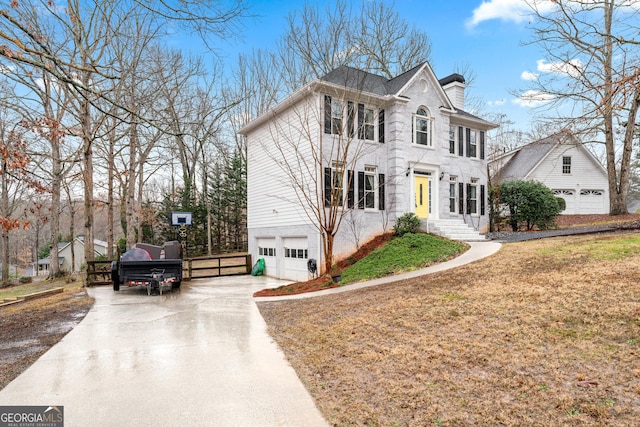 view of front of property with a garage and a front lawn