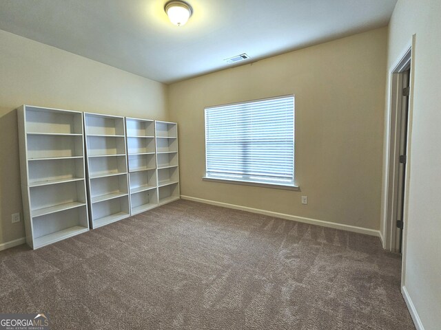 unfurnished bedroom featuring dark carpet