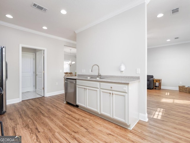 kitchen with appliances with stainless steel finishes, sink, white cabinets, and light wood-type flooring