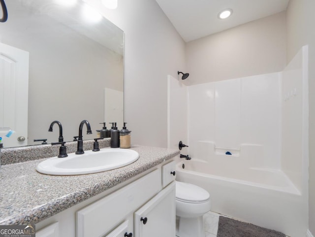 full bathroom featuring vanity, bathing tub / shower combination, and toilet