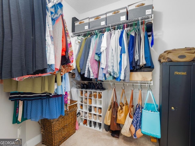 walk in closet with carpet