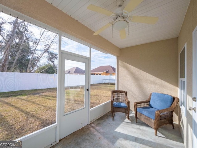 sunroom / solarium featuring ceiling fan