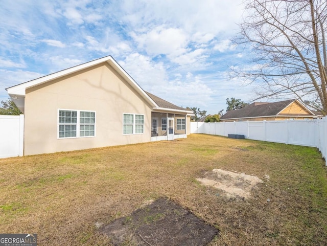 back of house with a yard