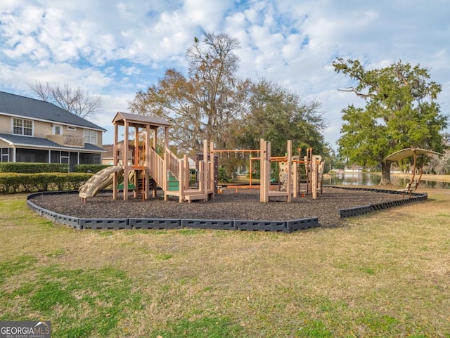 view of jungle gym featuring a yard and a water view