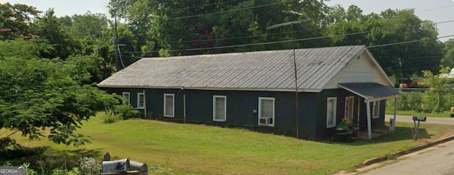 view of side of home featuring a lawn