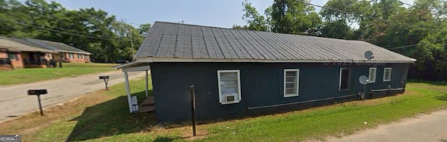 view of side of home with a lawn