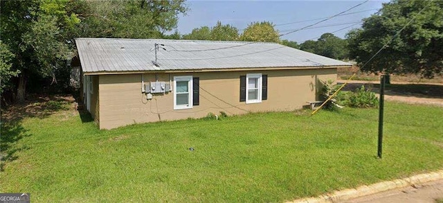 view of side of home featuring a lawn