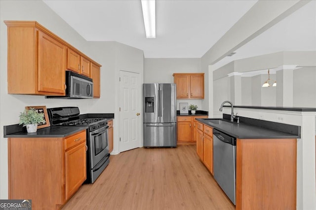 kitchen featuring stainless steel appliances, sink, and light wood-type flooring