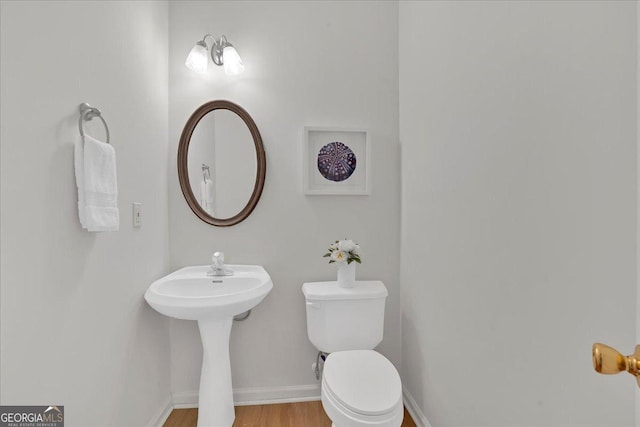 bathroom featuring toilet and hardwood / wood-style floors