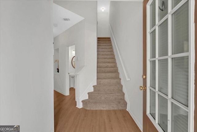 stairs with hardwood / wood-style floors