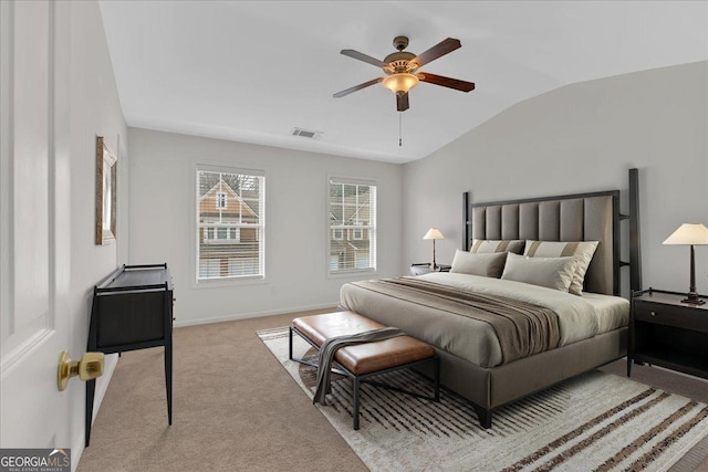 bedroom featuring vaulted ceiling, light carpet, and ceiling fan