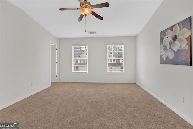 unfurnished room featuring ceiling fan and light carpet