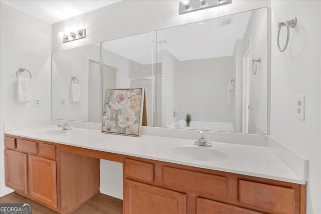 bathroom featuring vanity, wood-type flooring, and walk in shower