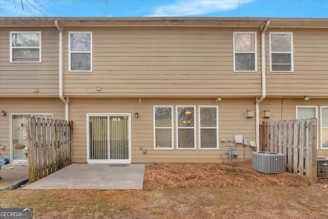 rear view of property featuring cooling unit and a patio