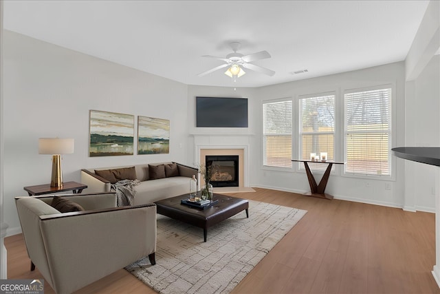 living room featuring ceiling fan and light wood-type flooring