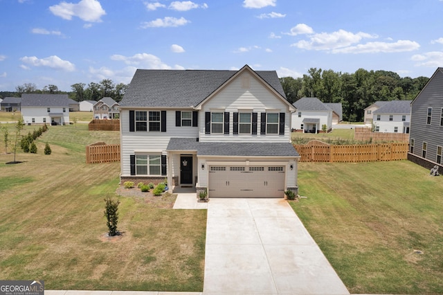 view of front of house with a garage and a front yard